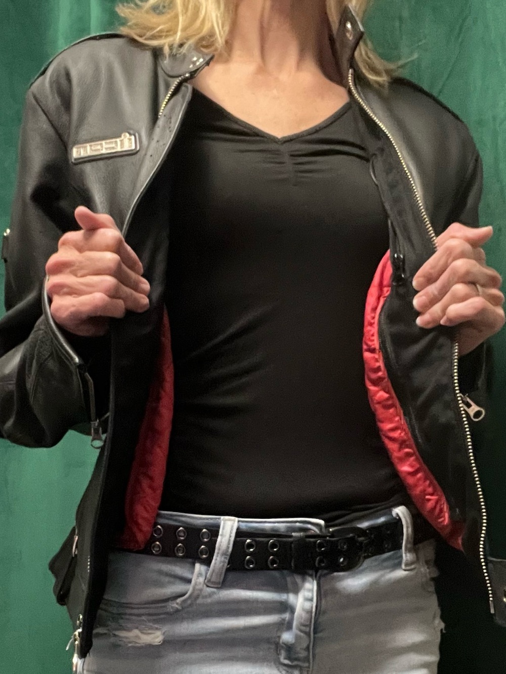ICON Black Leather Jacket with quilted red lining and chrome/silver buckles.